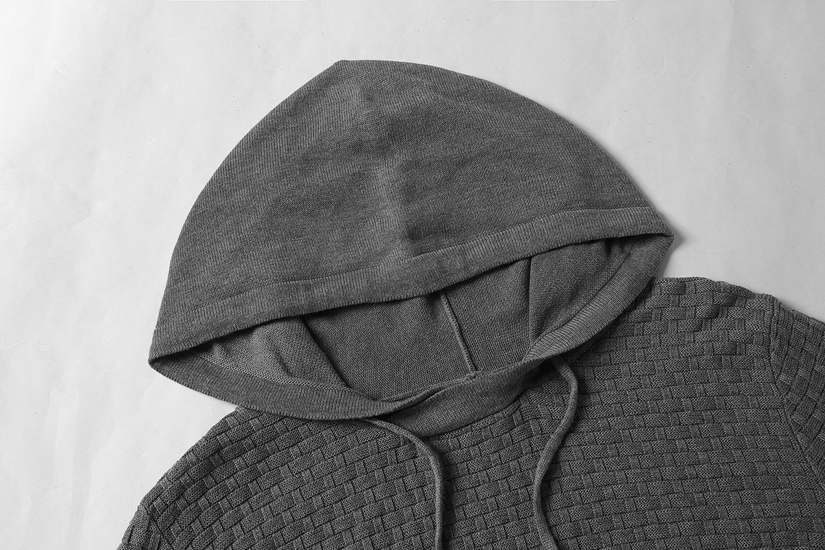 Gray textured hooded garment on a light gray background