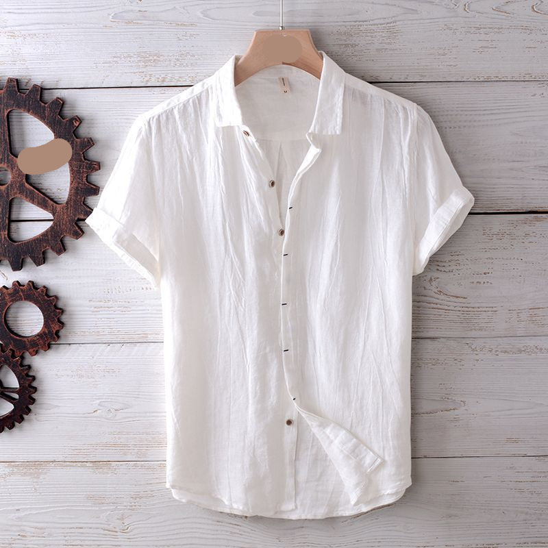 White button-up shirt on a wooden hanger with gears on a wooden surface