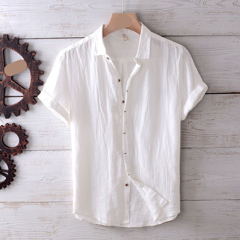 White button-up shirt on a wooden hanger with gears on a wooden surface